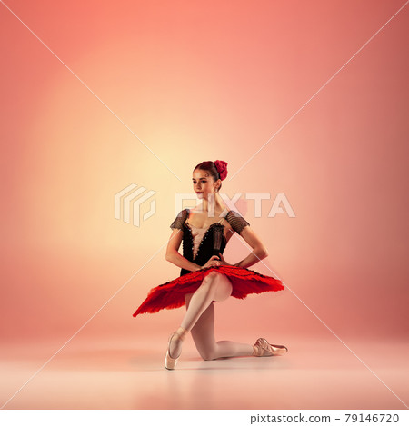 Young and incredibly beautiful ballerina is posing and dancing at red studio full of light. Young and incredibly beautiful ballerina is posing and dancing at red studio full of light. 79146720