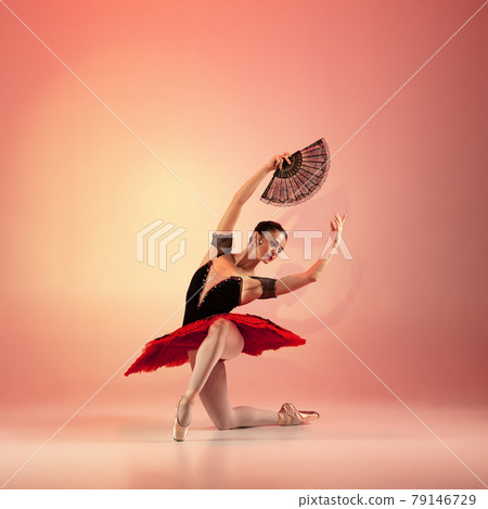 Young and incredibly beautiful ballerina is posing and dancing at red studio full of light. Young and incredibly beautiful ballerina is posing and dancing at red studio full of light. 79146729