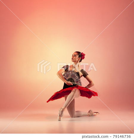 Young and incredibly beautiful ballerina is posing and dancing at red studio full of light. Young and incredibly beautiful ballerina is posing and dancing at red studio full of light. 79146736