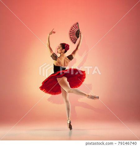 Young and incredibly beautiful ballerina is posing and dancing at red studio full of light. Young and incredibly beautiful ballerina is posing and dancing at red studio full of light. 79146740