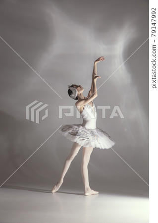 Young graceful balerina in image of white swan in art performance isolated on gray white background. 79147992