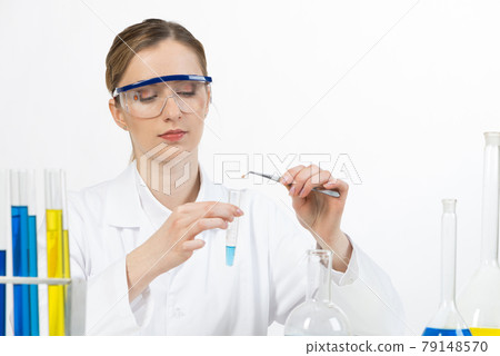 Young female research scientist puts sample 79148570