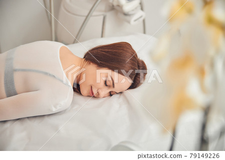 Attractive young lady having good time at cosmetology center 79149226