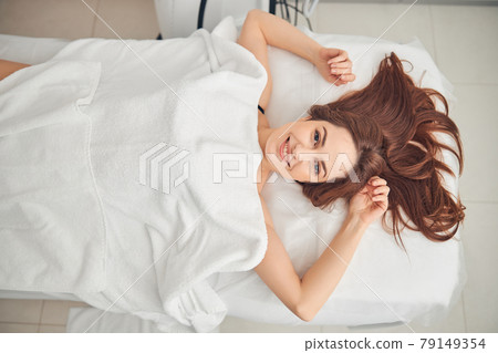 Attractive woman with dark hair covered with white towel 79149354