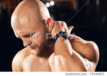 Handsome sportsman cringing from neck muscle soreness Handsome sportsman cringing from neck muscle soreness 79149851