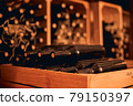 Dusty bottles of red wine in wooden crate 79150397