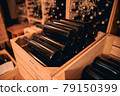 Dusty bottles of wine in storage room or wine cellar 79150399