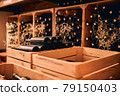 Wooden crates with glass wine bottles in wine cellar 79150403