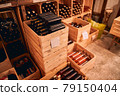 Wooden crates with wine bottles in storage room 79150404