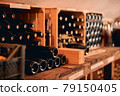 Glass bottles of wine in wooden crates 79150405