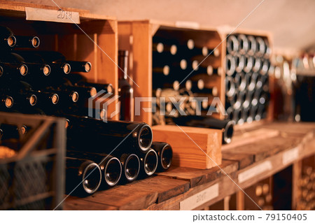 Glass bottles of wine in wooden crates 79150405