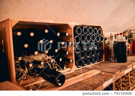 Storage room with wine bottles in wooden crates 79150406