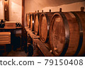 Wooden barrels with wine in storage room 79150408