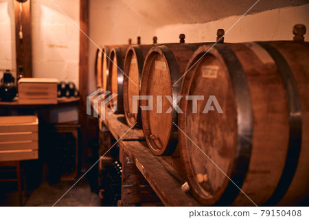 Wooden barrels with wine in storage room Wooden barrels with wine in storage room 79150408