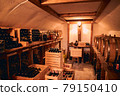 Storage room with wine in bottles and barrels. 79150410