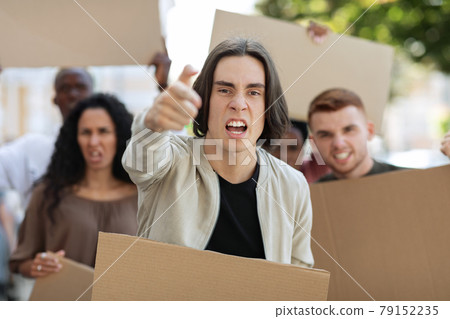 Angry guy leading multiracial group of protestors Angry guy leading multiracial group of protestors 79152235
