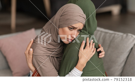 Unhappy Muslim Woman Hugging Depressed Senior Mother At Home, Panorama Unhappy Muslim Woman Hugging Depressed Senior Mother At Home, Panorama 79152318