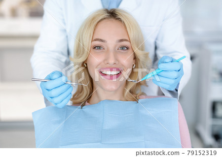 Portrait of smiling female patient attending dental clinic 79152319
