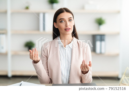 Young Businesswoman Talking To Camera Consulting Sitting In Modern Office 79152516