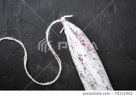 Spanish traditional longaniza sausage on black surface 79152902