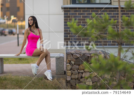 fashion urban portrait of young, slim, beautiful model in pink dress. 79154649