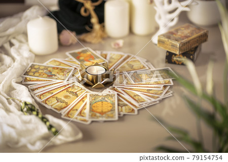 Defocused mystic ritual with tarot cards, fortune telling and esoteric symbols.  79154754