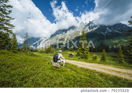 Traveler resting on hiking trail enjoying Wilder Kaiser mountains, Tirol - Austria 79155828