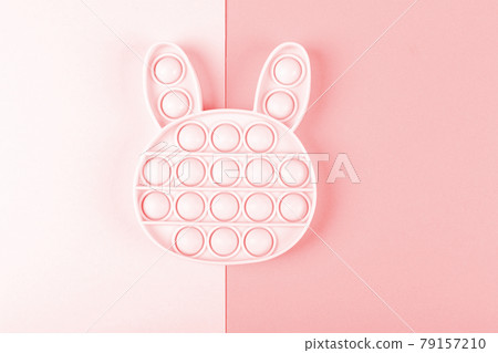 New silicone fidget toys pop it in shape of bunny on the pink background. New silicone fidget toys pop it in shape of bunny on the pink background. 79157210