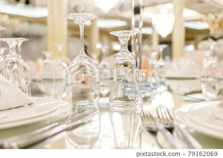 Mirror table festive setting in luxury restaurant. Glasses, plates, cutlery on mirror table. shallow depth of field Mirror table festive setting in luxury restaurant. Glasses, plates, cutlery on mirror table. shallow depth of field 79162069