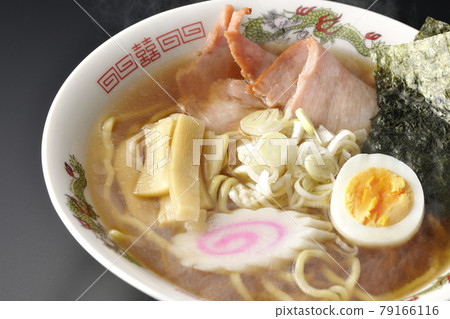 A traditional hot soy sauce ramen that you can eat at a stall with various ingredients such as char siu on a black background A traditional hot soy sauce ramen that you can eat at a stall with various ingredients such as char siu on a black background 79166116