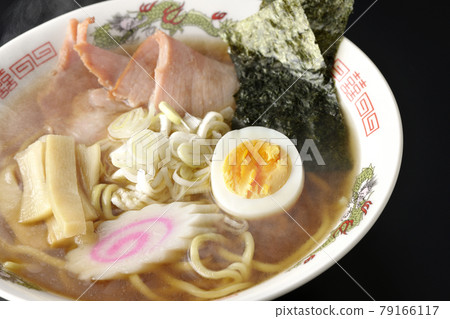 A traditional hot soy sauce ramen that you can eat at a stall with various ingredients such as char siu on a black background 79166117