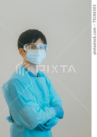 Healthcare workers wearing isolation gowns and nitrile gloves Healthcare workers wearing isolation gowns and nitrile gloves 79166303