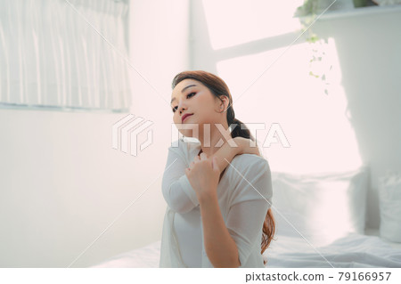 Close up shot of smiling woman in bed room Close up shot of smiling woman in bed room 79166957