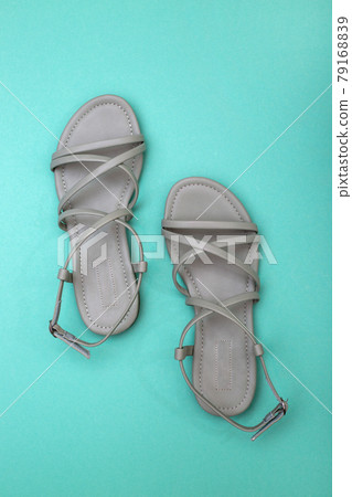 Women's summer sandals on a turquoise background, top view Women's summer sandals on a turquoise background, top view 79168839