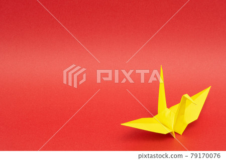 Yellow paper crane on a red background 79170076