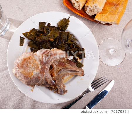 Delicious fried pork chops with stewed beans served Delicious fried pork chops with stewed beans served 79170854