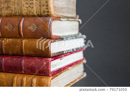 Stack of old books on dark background Stack of old books on dark background 79171050