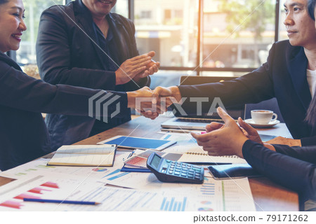 Team Business Partners shaking hands together to Greeting Start up small business in meeting room. Shakehand teamwork partners at modern office handshake together. Business mergers and acquisitions Team Business Partners shaking hands together to Greeting Start up small business in meeting room. Shakehand teamwork partners at modern office handshake together. Business mergers and acquisitions 79171262