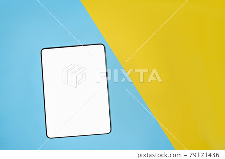 Mock up digital tablet on two tone blue and yellow background. 79171436