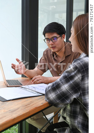 Businesspeople discussing their new project in modern office. 79171437