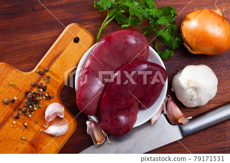 Raw pork kidneys on wooden table Raw pork kidneys on wooden table 79171531