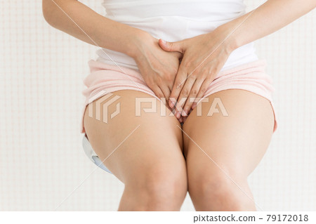 Woman holding her crotch 79172018