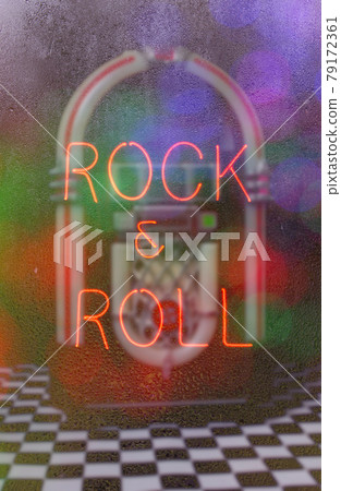 Jukebox with Neon Sign in Rainy Window Rock and Roll Jukebox with Neon Sign in Rainy Window Rock and Roll 79172361
