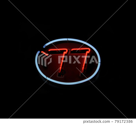 Vintage Neon 77 Sign in Restaurant Window Black Background Vintage Neon 77 Sign in Restaurant Window Black Background 79172386