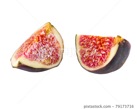 Two slices of purple fig isolated on white background with copy space. Soft, sweet fruit, skin is thin, red flesh has many seeds. Close-up. Two slices of purple fig isolated on white background with copy space. Soft, sweet fruit, skin is thin, red flesh has many seeds. Close-up. 79173716