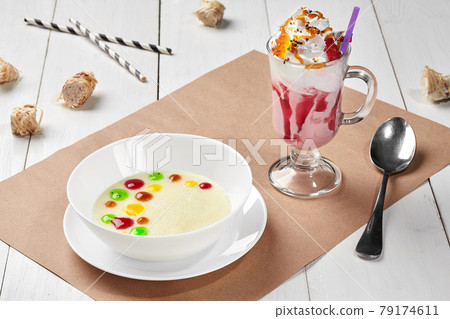 Sweet semolina porridge with fruit toppings and berry milkshake Sweet semolina porridge with fruit toppings and berry milkshake 79174611