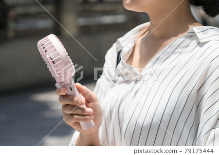 Business woman with a handy fan 79175444