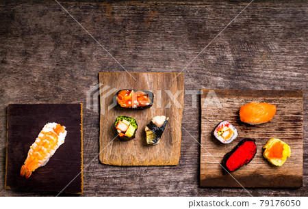 Sushi Set sashimi and sushi rolls served on wood Sushi Set sashimi and sushi rolls served on wood 79176050