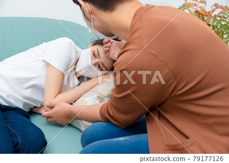 Man taking care of sick family member 79177126