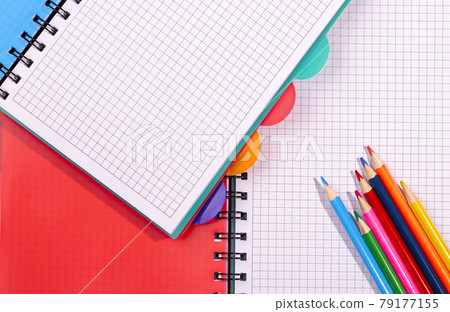 colored notebooks and pencils. Pencils on an empty notebook 79177155